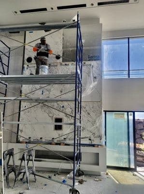 SNV crew member installing stone wall cladding
